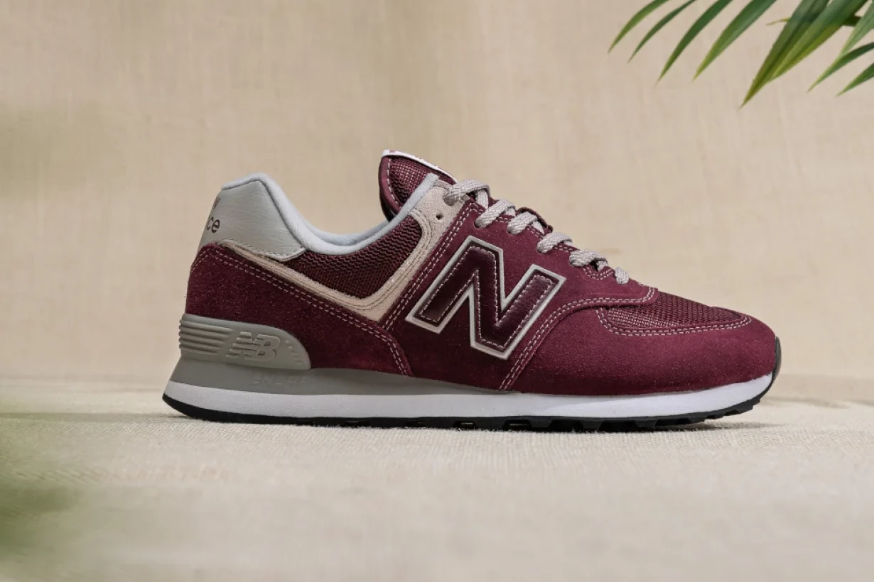 Wide Fit Shoes Shopify Bespoke Store Design image of a New Balance trainer on a background