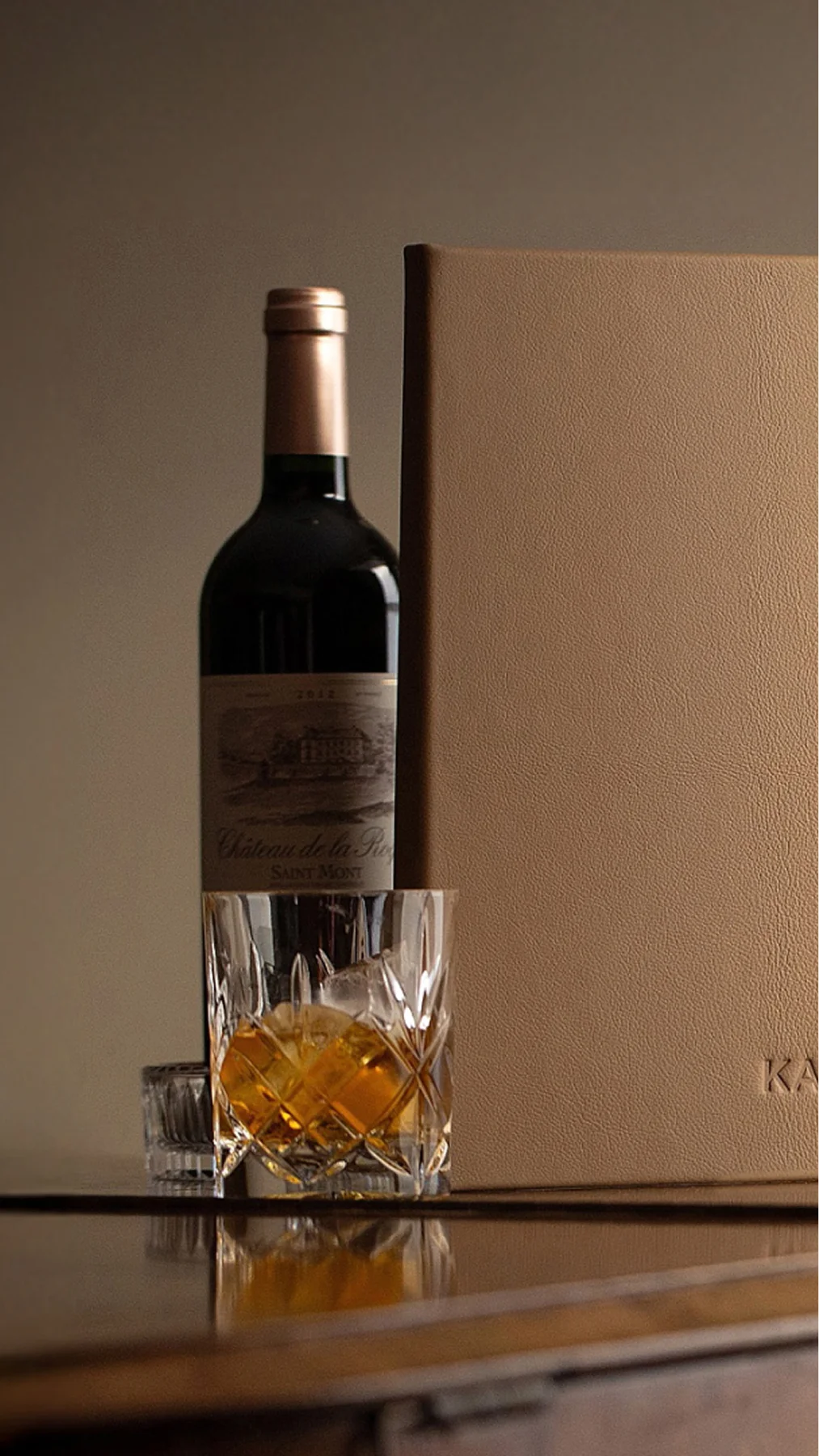 Bespoke book binder next to a glass of whiskey on top of a piano